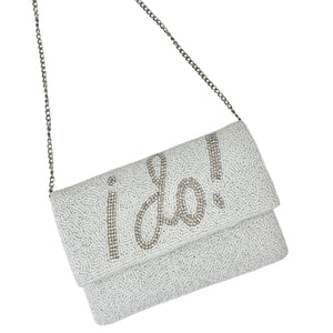 Elegant white clutch with sparkling beads, featuring the words "I Do!" in bold, silver lettering. It has a silver chain, conveying a bridal theme.