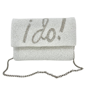 Elegant white clutch with sparkling beads, featuring the words "I Do!" in bold, silver lettering. It has a silver chain, conveying a bridal theme.
