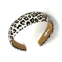 Load image into Gallery viewer, Leopard print headband with a smooth, rounded shape on a white background. The pattern is bold and stylish, conveying a trendy, fashionable vibe.