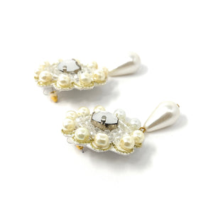 Elegant earrings feature clear beads surrounded by small pearls in a floral pattern, with a pearl teardrop dangling below, creating a classic, refined look.