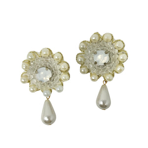 Elegant earrings feature clear beads surrounded by small pearls in a floral pattern, with a pearl teardrop dangling below, creating a classic, refined look.