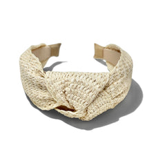 Load image into Gallery viewer, A cream-colored woven straw headband with a central knotted bow detail, shown on a clean white background with a soft shadow.