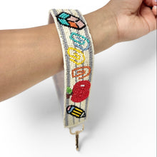 Load image into Gallery viewer, Beaded bracelet with colorful designs on a wrist against a white background