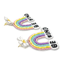 Load image into Gallery viewer, Pastel rainbow dangle earrings with floral tops and beaded “Be Kind” detail for playful everyday style.