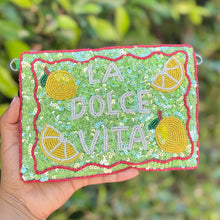 Load image into Gallery viewer, Green sequin pouch featuring “La Dolce Vita” lettering, bright lemon beadwork, and sparkling citrus-inspired details on a white background.
