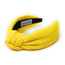 Load image into Gallery viewer, Vibrant yellow knotted headband crafted from textured fabric with a bold, cheerful look.