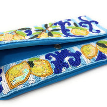 Load image into Gallery viewer, A blue beaded clutch purse featuring intricate floral and scroll beadwork in blue, yellow, green, and white, with a snap button closure.