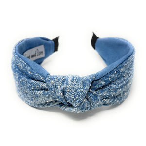 Blue denim headband with a knot design and small scattered rhinestones for sparkle, conveying a chic style.