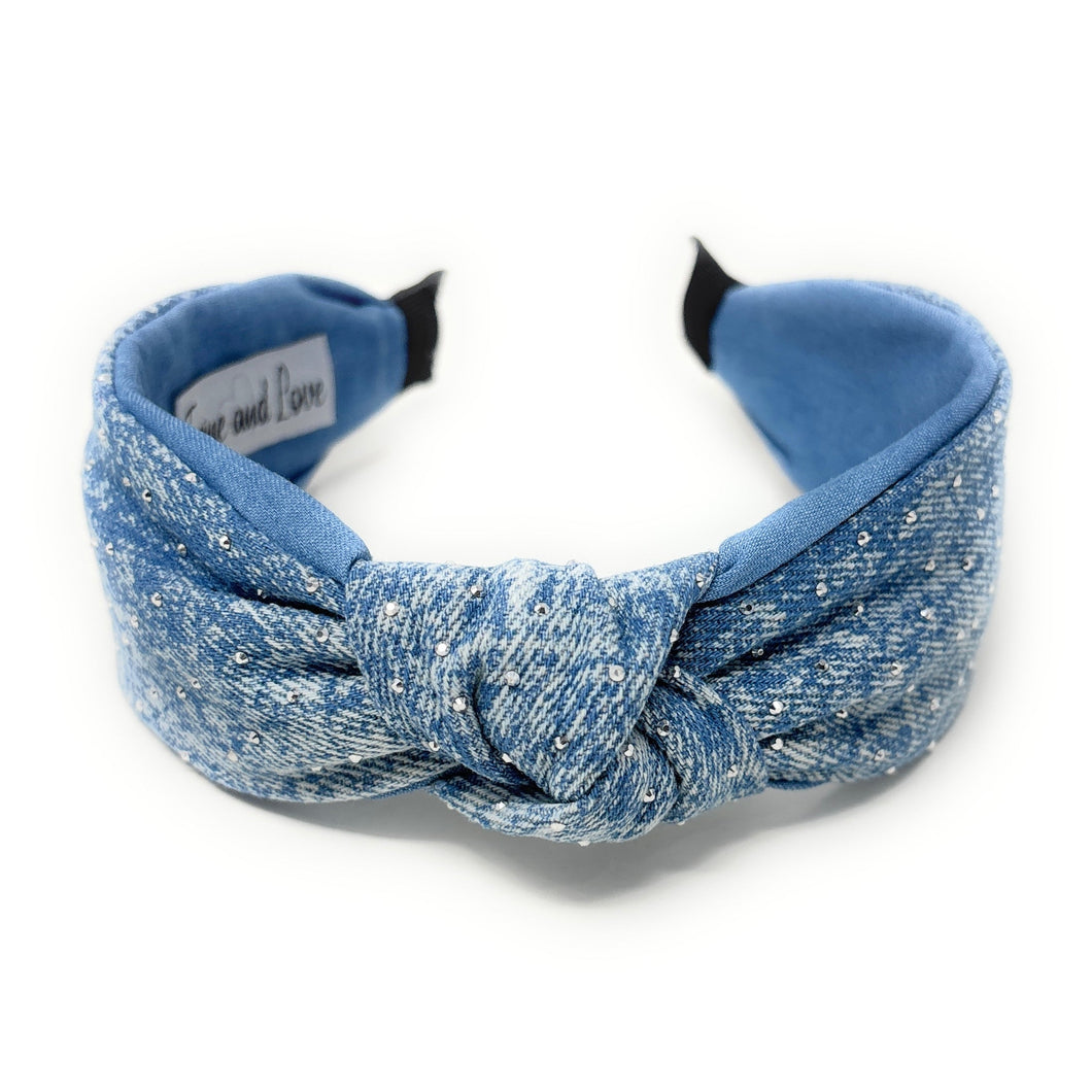 Blue denim headband with a knot design and small scattered rhinestones for sparkle, conveying a chic style.