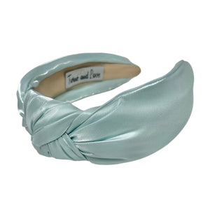 Light blue satin headband on a white background
