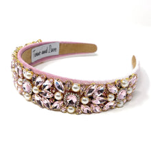 Load image into Gallery viewer, Pink jeweled headband adorned with sparkling pink gemstones and pearls on a soft pink fabric. Elegant, luxurious, and feminine design.
