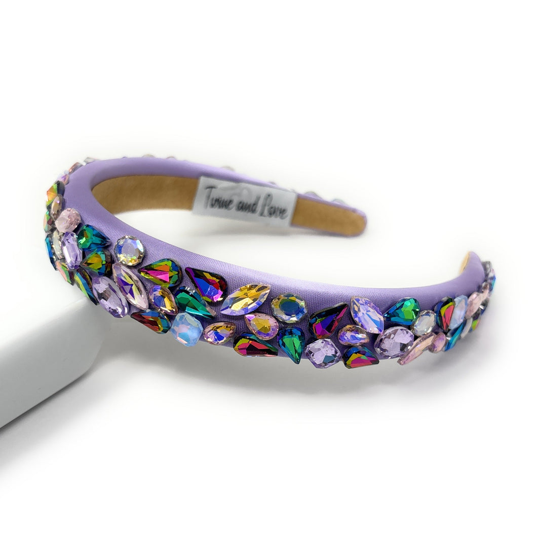 Decorative headband with colorful crystals on a white background