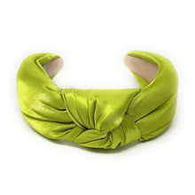 Load image into Gallery viewer, A vibrant green satin headband with a twisted knot design, labeled &quot;True and Love&quot; inside. The fabric&#39;s sheen adds a touch of elegance.