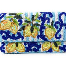 Load image into Gallery viewer, A close up of a rectangular beaded clutch purse featuring a pattern of yellow lemons with green leaves and blue scrollwork on a white and light blue striped background.