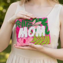 Load image into Gallery viewer, Person holding a pink clutch with 'MOM' and floral designs outdoors