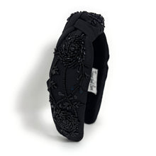 Load image into Gallery viewer, Handmade black knot headband with intricate beaded roses, shimmering sequins, and elegant all-black detailing on a padded silhouette.
