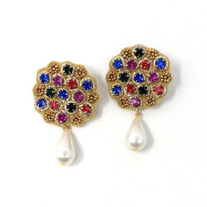 Gold earrings with a scalloped edge, featuring blue, red, green, and purple gemstones. Each earring has a dangling white teardrop pearl, exuding elegance.
