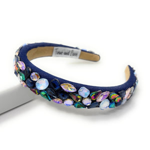 Navy blue headband with colorful gemstones on a white background