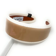 Load image into Gallery viewer, Wide glossy beige patent headband with ivory trim and a sleek minimalist design displayed on a white background.
