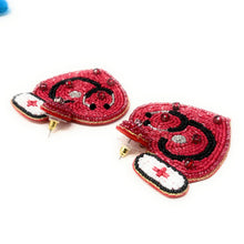 Load image into Gallery viewer, Playful nurse-inspired earrings featuring a red heart design with medical-themed embellishments.