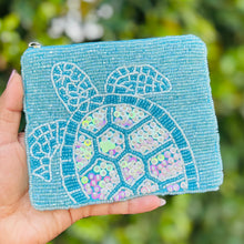 Load image into Gallery viewer, Light blue beaded pouch featuring a sea turtle design with sequins and zip closure.
