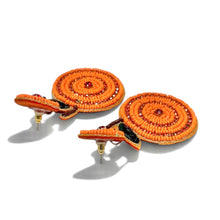 Load image into Gallery viewer, Vibrant orange beaded drop earrings with concentric patterns, crystal centers, and green leaf details for a fresh summer look