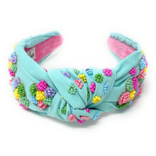 Load image into Gallery viewer, Colorful rainbow statement earrings with “Be Kind” lettering styled with a pastel beaded headband and casual outfit.