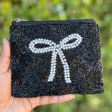 Load image into Gallery viewer, Elegant black beaded coin purse with a large white pearl bow on the front.