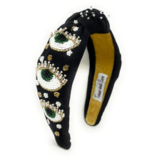 Load image into Gallery viewer, Elegant black padded headband with protective eye-inspired beadwork, gold crystals, and pearl accents.