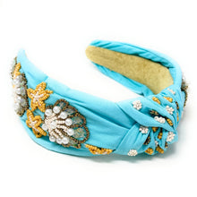Load image into Gallery viewer, Stylish portrait of a woman in a red strapless top wearing a jeweled blue headband and pearl beaded star earrings.