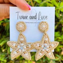 Load image into Gallery viewer, Pearl beaded starfish earrings with gold accents, crystal details, and handcrafted coastal-inspired embroidery.