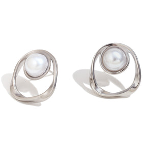 Pair of silver earrings with pearl-like stones on a white background