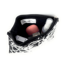 Load image into Gallery viewer, Small pouch with cosmetic items on a white background