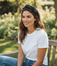 Load image into Gallery viewer, Woman sitting on a bench outdoors with a blurred garden background