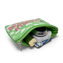 Load image into Gallery viewer, A green beaded zippered pouch with pink and white lettering, shown open with a camera and card tucked inside, on a white background.
