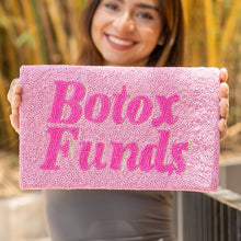 Load image into Gallery viewer, Woman holding a pink sign with 'Botox Funds' text against a bamboo background