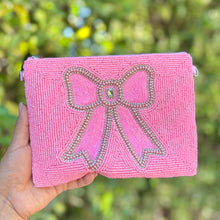 Load image into Gallery viewer, Pink beaded zip pouch with large bow design outlined in rhinestones and sequins.