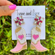 Load image into Gallery viewer, Woman wearing a pink pearl-embellished knotted headband and beaded cowboy boot earrings, styled with a black ruffle-sleeve dress against a wooden backdrop.