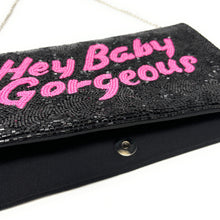 Load image into Gallery viewer, Elegant black beaded envelope clutch with pink “Hey Baby Gorgeous” design, styled as a chic statement accessory.
