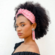 Load image into Gallery viewer, Close-up portrait featuring a blush pink headband adorned with pearls and a front knot detail, creating a chic and feminine look.