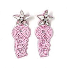 Load image into Gallery viewer, Sparkly pink beaded Sold earrings featuring rhinestone star accents against a blurred greenery background.