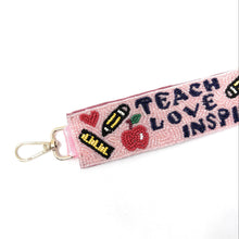Load image into Gallery viewer, Keychain with 'Teach Love Inspire' text and educational symbols on a pink background