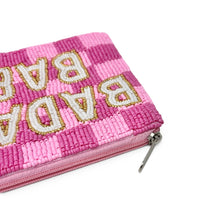 Load image into Gallery viewer, A pink checkered zippered pouch in raised white letters with gold outlines, photographed on a clean white background.