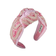 Load image into Gallery viewer, Pink headband with decorative elements on a white background