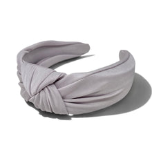 Load image into Gallery viewer, A pearl pink gray satin headband with a knotted twist detail, displayed on a clean white background with a soft shadow.