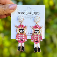 Load image into Gallery viewer, Pink Nutcracker Beaded Earrings, Christmas Earrings, Holiday Earrings, Christmas Beaded Earrings, Seed Bead, Merry Christmas, Pink Nutcracker soldier earrings, pink beaded earrings, Christmas beaded earrings, pink bead earrings, Pink holiday earrings, holiday earrings, Nutcracker earrings, Pink earrings, holiday gifts, holiday accessories, holiday beaded accessories, Holiday Pink accessories, Holiday Christmas earrings, Christmas gifts, Best seller, best Selling items, Christmas earrings, Custom earrings