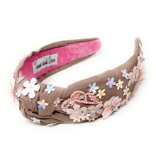 Load image into Gallery viewer, light Brown headband with pink interior, adorned with colorful floral applique and beading. The vibe is playful and feminine, showcasing detailed craftsmanship.