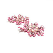Load image into Gallery viewer, Pink beaded snowflake earrings with pearl accents on a white background. The intricate design is festive and elegant, highlighting craftsmanship. 