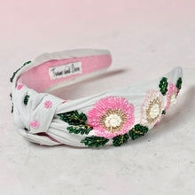 Load image into Gallery viewer, White headband with pink floral embellishments on a light gray background