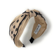 Load image into Gallery viewer, Beige headband with black polka dots on a white background